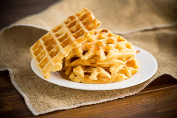 sweet cooked aromatic Belgian waffles in a plate