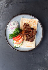 Lamb rack in a plate with vegetables.