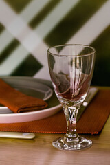 Empty wineglass on the table with plates