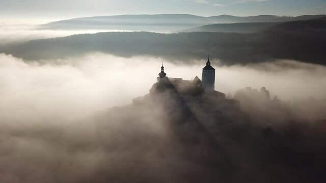 Cinematic sunrise aerial drone footage of the charming historical quaint old medieval European Burg Forchtenstein Castle in Burgenland Austria