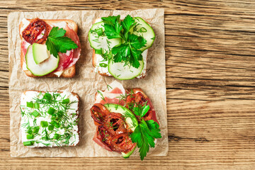 toasts slices and sandwich on a paper, wooden background