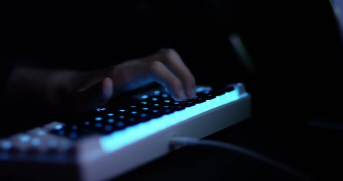 Professional gamer plays in strategy video game on his computer.