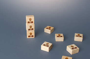 Fototapeta premium Figurine block tower with people. Hierarchical system. Company organization. Hiring, recruiting. Team building personnel leadership. Effective productive business employees group collectives.