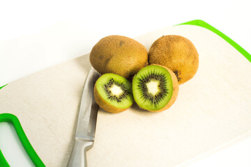 Green kiwi sliced lies on the cutting board