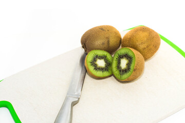Green kiwi sliced lies on the cutting board