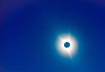 The moon covers the sun in a beautiful solar eclipse, bright stars in the sky