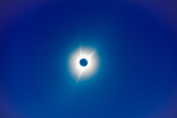 The moon covers the sun in a beautiful solar eclipse, bright stars in the sky