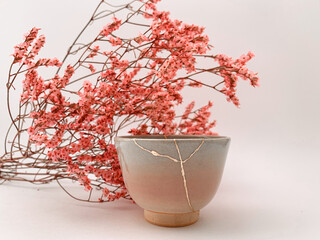 Kintsugi, Japanese Hanami flowers with real gold restored pottery, golden scarsa and cherry blossoms