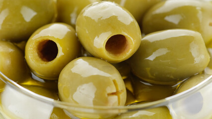pitted green olives close up on white background