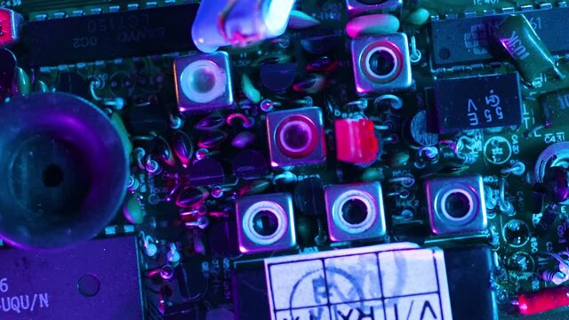 Close up of electronic board with cyber pink sci fi futuristic light effects