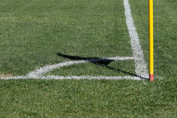 Football field in natural grass. Corner kick line with flag