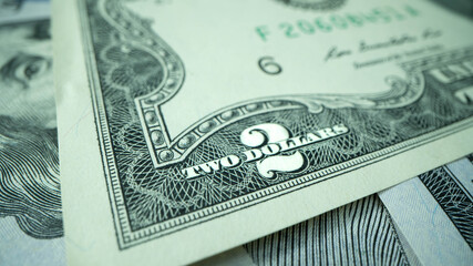 Macro shot of dollars. Stack of two dollars bills close-up.
