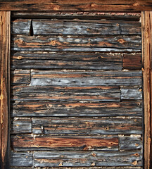 The surface of an old wooden wall with a frame on the edges. Natural vintage wood background. Vertical orientation.