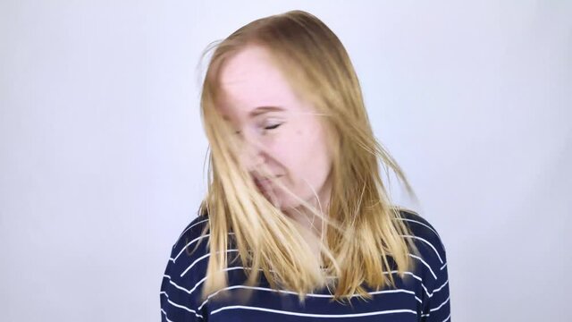 The girl looks in front of the mirror at her oily hair. Problematic scalp and increased secretion of the sebaceous glands. Hair care. Oily hair care and treatment concept