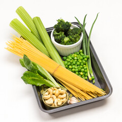 Pasta, vegetables and cashew nuts in pallet.