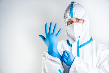 The doctor puts on blue gloves to protect against the corona virus. He is ready to be vaccinated.