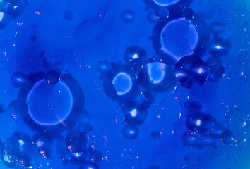 Blue background. An abstraction. Oil circles on the water