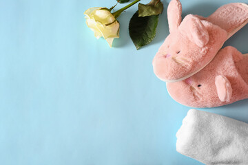 women's slippers and towels on a blue background