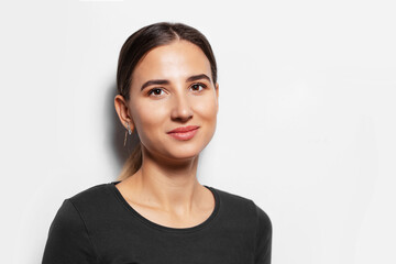 Fototapeta premium Studio portrait of young confident girl on white background.