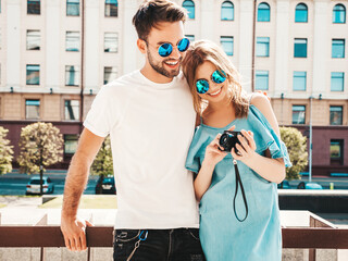 Portrait of smiling beautiful woman and her handsome boyfriend. Woman in casual summer jeans dress....