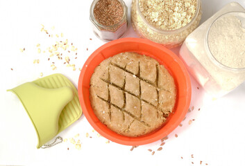 Making homemade rye flour bread with flax and oat seeds, isolated on white background