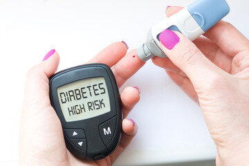 Check and monitor blood sugar or glucose with glucometer from finger
