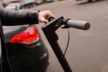 Close-up of the steering wheel of an electric scooter outside © brillianata