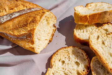 Delicious fresh baked baguette cut on a wooden cutting board