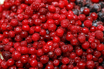 Currant and lingonberry berries sprinkled with sugar close-up. Healthy food.