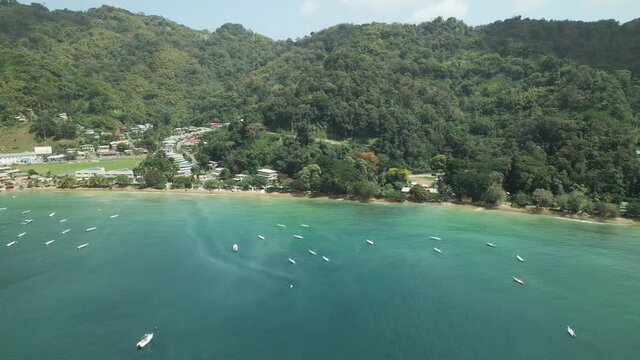 Aerial pan left revealing the jetty and fishing village of Charlotteville, Tobago
