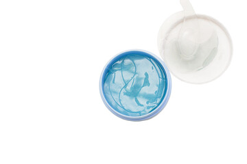 Hydrogel eye patches in cotainer with spatula. Isolated white background, copy space