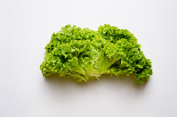 Fresh green lettuce leaves. Salad on a white plate.