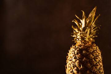 Pineapple tropical fruit on black background. Citrus fruit with vitamin c for helth care