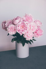 Fresh spring bouquet of pink peonies in full bloom in vase, close up. Summer flowers.