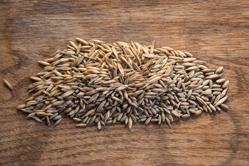 Close up of winter rye and oat seeds on wooden table