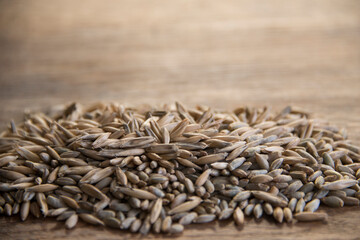 Close up of winter rye and oat seeds on wooden table