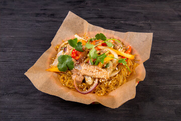 Noodles wok with chicken, vegetables and greens