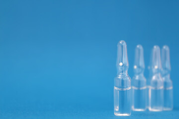 ampoules with medicine on a blue background