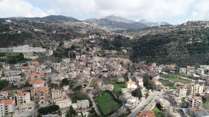 Fototapeta na wymiar Aerial view of the city. Middle east region. Beauty of Lebanon. Houses near the valley and mountains. Spring season. Best travel destinations. Vacation time