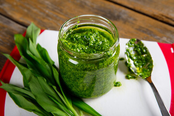 Fresh homemade wild garlic pesto. Home made sauce made with wild garlic, pine nuts, cheese and olive oil.