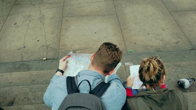 Couple tourists looking at Map 4k