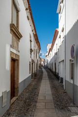 View of a street in the historic old town, with local businesses, in Miranda do Douro, Portugal