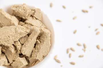 sunflower halva on a white table with seeds