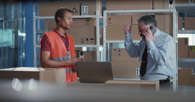 Nervous stressful adult boss yelling on afro-american worker guilty for bad mistake in financial report. Problems at work. Delivery office department.