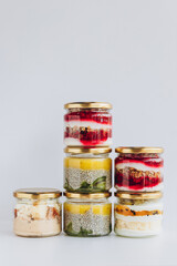 Trendy organic desserts in jars on a solid background. Concept for cafes, restaurants and restaurants with healthy products
