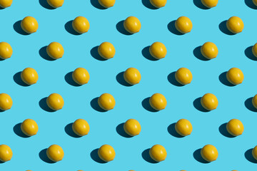 Yellow lemon on a blue background. Lemon pattern on a blue background background. Hard shadows