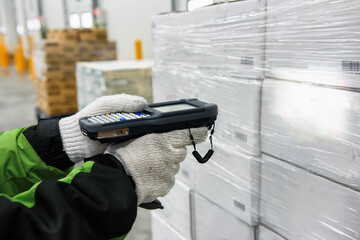 Bluetooth barcode scanner checking goods in the cold room or warehouse. Selection focus shooting on...