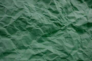 Top view photo of Crumpled craft paper. Emerald color Paper background with copyspace. Vintage paper canvas texture abstract background.