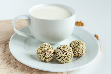 truffles with cocoa, coconut and sesame with chocolate and marshmallows and a cup of fresh milk, delicious dessert
