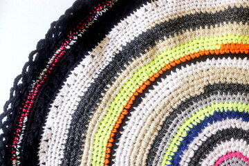 Handmade rug from strips of fabric multicolored close-up.